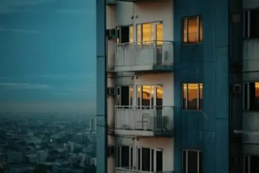 Lit balconies against a dusk sky